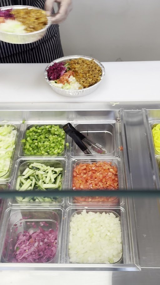 Takeout trays filled with chicken over rice